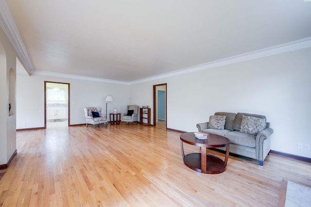912 S Lake St, Colfax, WA 99111 - living room featuring light wood-type flooring, crown molding, and arched walkways