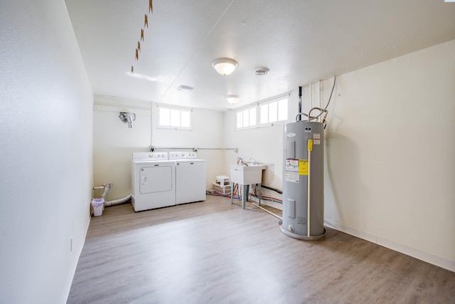 912 S Lake St, Colfax, WA 99111 - basement with electric water heater, washing machine and dryer, and wood finished floors