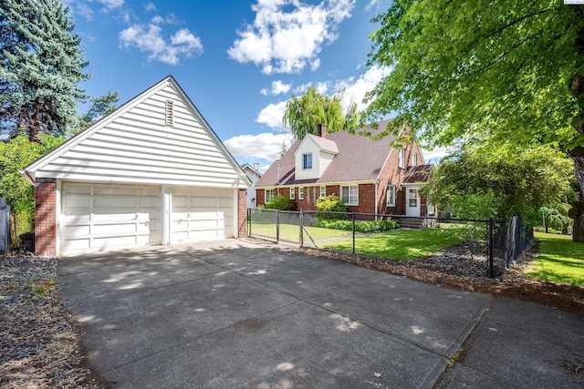 912 S Lake St, Colfax, WA 99111 - cape cod house with brick siding, an outdoor structure, a chimney, and driveway