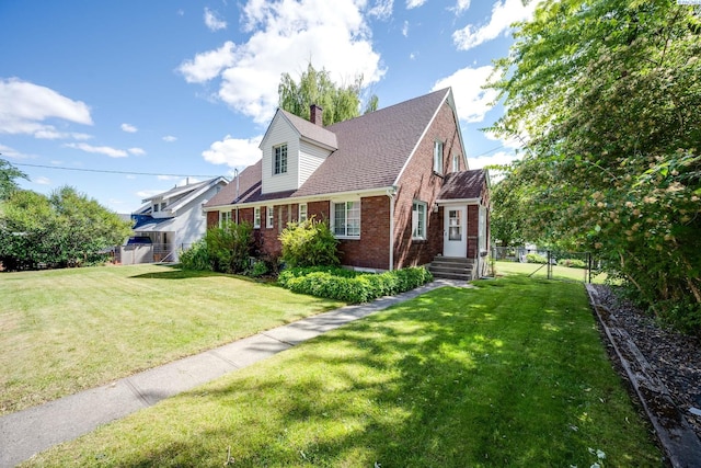 912 S Lake St, Colfax, WA 99111 - cape cod house featuring brick siding, a chimney, and a shingled roof