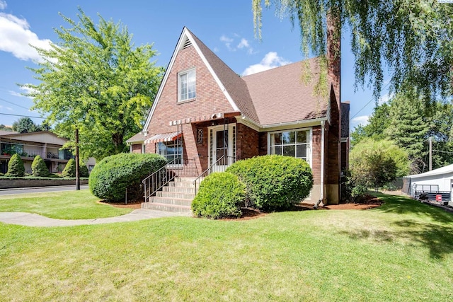 912 S Lake St, Colfax, WA 99111 - view of front of property featuring brick siding, a front yard, and a chimney