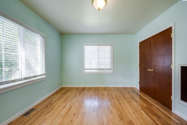 912 S Lake St, Colfax, WA 99111 - unfurnished bedroom featuring multiple windows and light wood-style floors