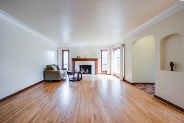 912 S Lake St, Colfax, WA 99111 - living room with healthy amount of natural light, a high end fireplace, crown molding, and light wood-style flooring
