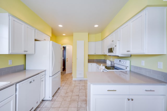 912 S Lake St, Colfax, WA 99111 - kitchen with white appliances, white cabinetry, recessed lighting, light countertops, and a peninsula