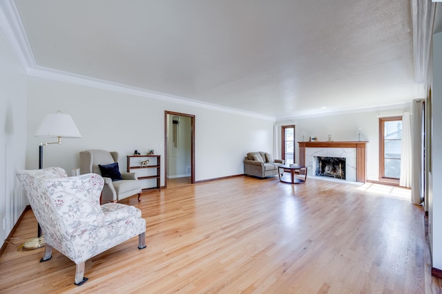 912 S Lake St, Colfax, WA 99111 - living area with healthy amount of natural light, crown molding, light wood-style flooring, and a high end fireplace