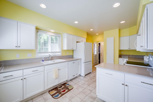 912 S Lake St, Colfax, WA 99111 - kitchen featuring white appliances, white cabinetry, arched walkways, light countertops, and recessed lighting
