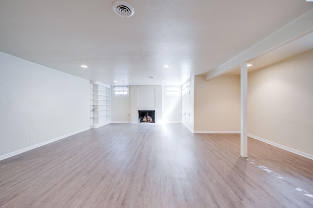 912 S Lake St, Colfax, WA 99111 - unfurnished living room with a fireplace, built in features, wood finished floors, and recessed lighting