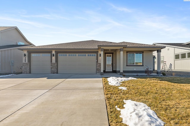 view of front facade with a front lawn, concrete driveway, an attached garage, and stucco siding