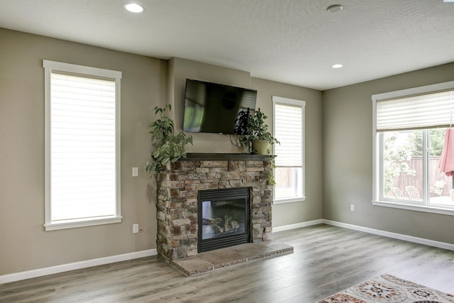 1390 Jade Ave, West Richland, WA 99353 - unfurnished living room with wood finished floors, a fireplace, baseboards, and recessed lighting
