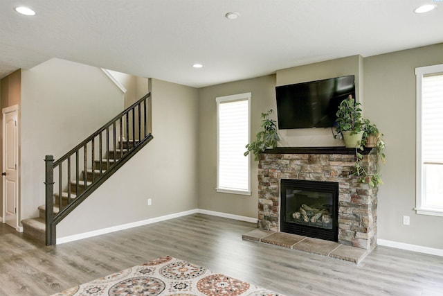 1390 Jade Ave, West Richland, WA 99353 - unfurnished living room featuring stairway, wood finished floors, baseboards, recessed lighting, and a fireplace