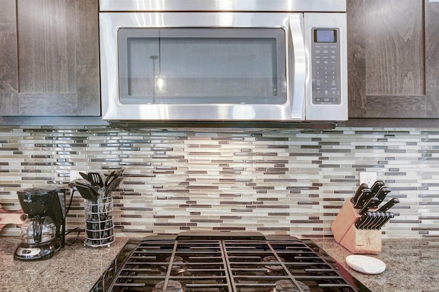 1390 Jade Ave, West Richland, WA 99353 - kitchen view of stainless steel microwave, decorative backsplash, and gas stovetop