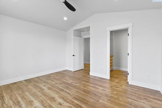 903 Ellen Ln, Zillah, WA 98953 - unfurnished bedroom with a walk in closet, vaulted ceiling, a closet, ceiling fan, and light hardwood / wood-style floors