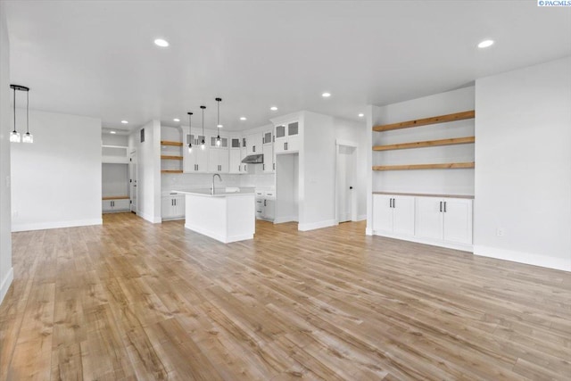 903 Ellen Ln, Zillah, WA 98953 - unfurnished living room with sink and light hardwood / wood-style flooring