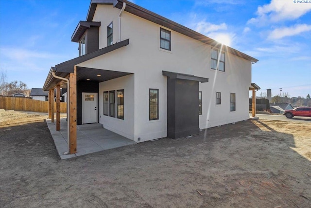 back of property with a patio