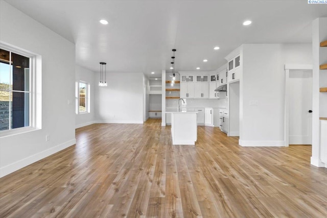 903 Ellen Ln, Zillah, WA 98953 - unfurnished living room featuring sink and light hardwood / wood-style floors