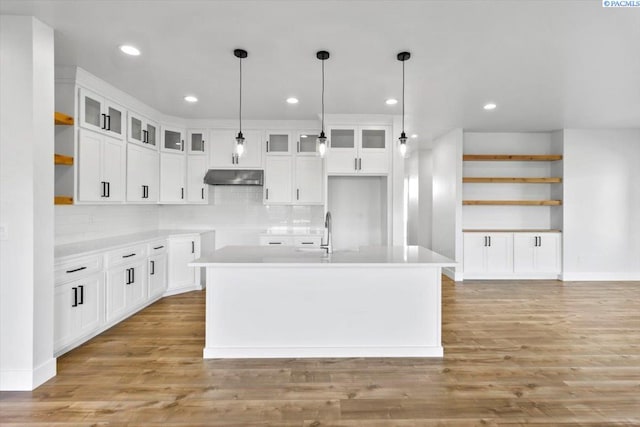 903 Ellen Ln, Zillah, WA 98953 - kitchen featuring pendant lighting, a kitchen island with sink, light hardwood / wood-style flooring, and white cabinets