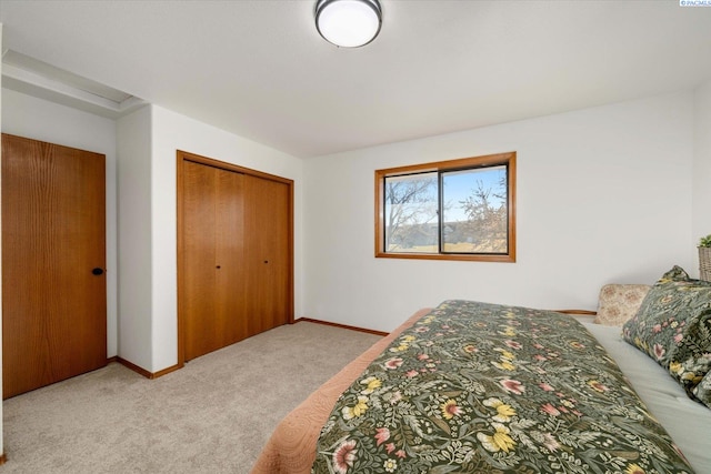 carpeted bedroom featuring a closet and baseboards