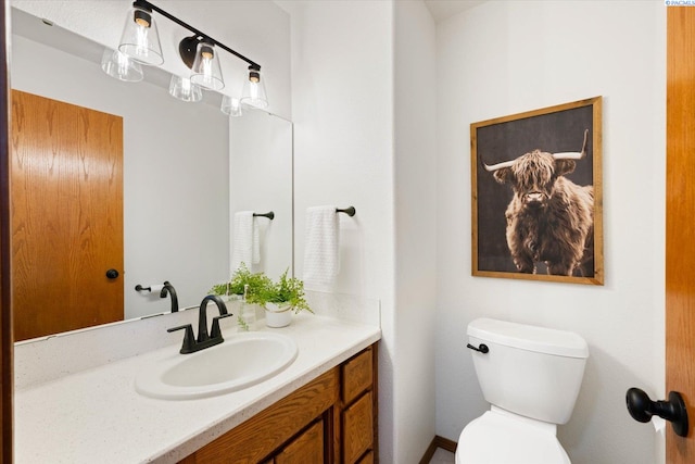 bathroom with toilet and vanity