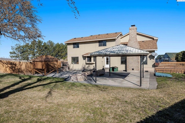 rear view of property with a lawn, a gazebo, crawl space, a patio area, and fence