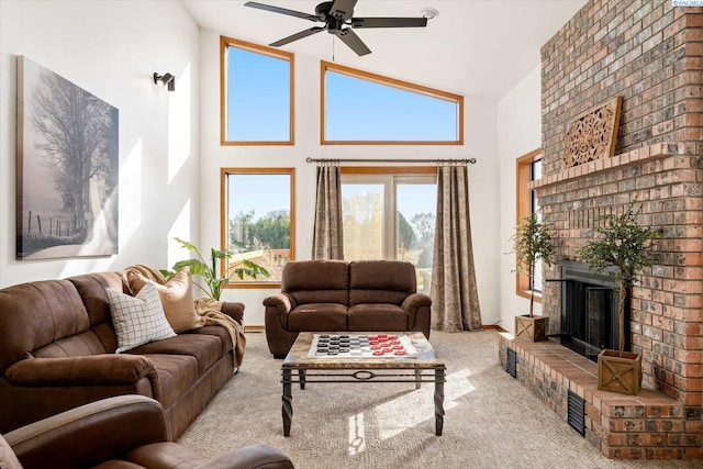 carpeted living room with a ceiling fan, a brick fireplace, and high vaulted ceiling