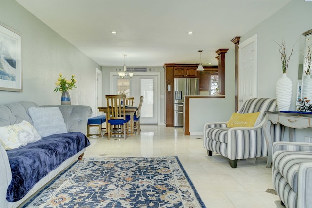 living room with a notable chandelier, light tile patterned floors, and recessed lighting