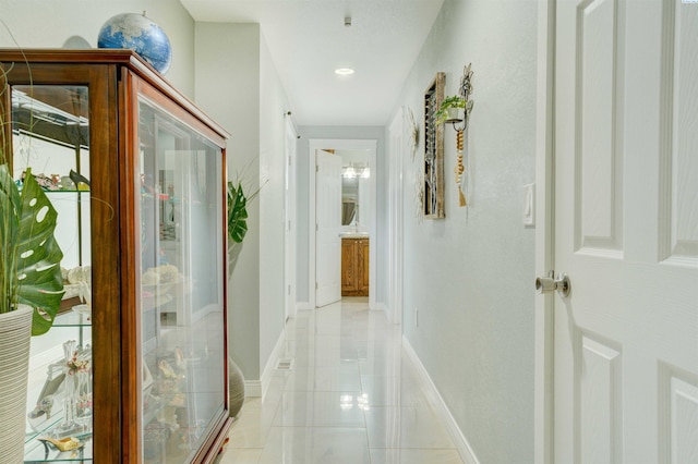 hall with light tile patterned floors and baseboards