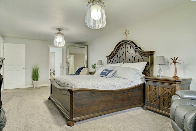 bedroom featuring light carpet and baseboards