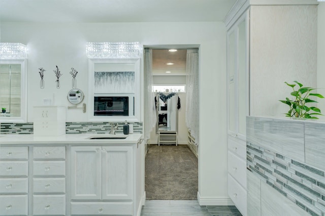 bathroom featuring vanity and tasteful backsplash