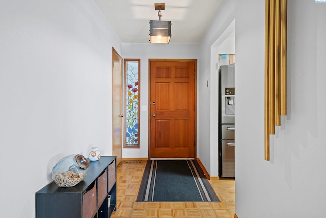 doorway to outside featuring baseboards