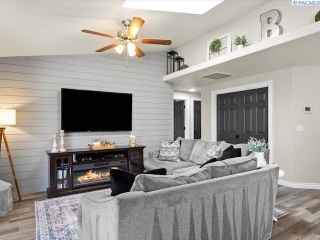 4210 Campolina Ln, Pasco, WA 99301 - living area featuring wood finished floors, ceiling fan, wooden walls, and vaulted ceiling