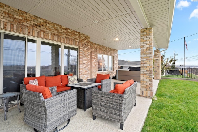 view of patio / terrace with an outdoor living space with a fire pit