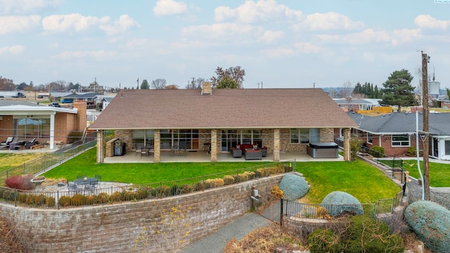 back of property with a hot tub