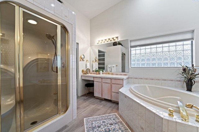 bathroom with vanity, plus walk in shower, and hardwood / wood-style floors