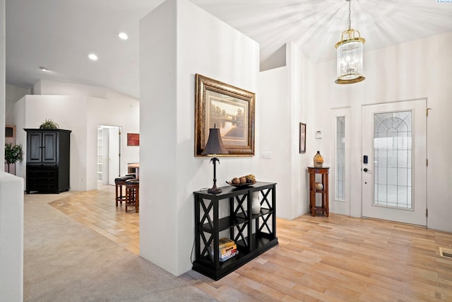 entryway with a notable chandelier and light wood-type flooring