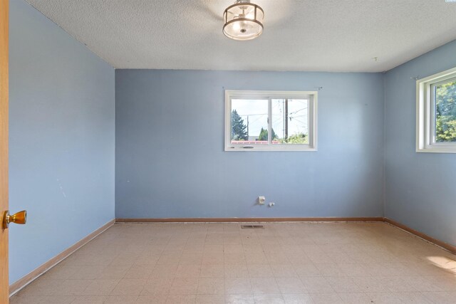 1506 Wilson St, Richland, WA 99354 - unfurnished room featuring a textured ceiling and tile patterned floors