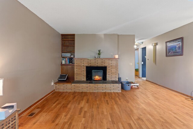 1506 Wilson St, Richland, WA 99354 - unfurnished living room with wood finished floors, a fireplace, and built in features