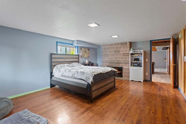 1506 Wilson St, Richland, WA 99354 - bedroom with wood finished floors and a fireplace