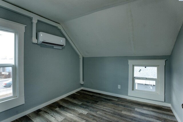503 Grandridge Ave, Grandview, WA 98930 - bonus room featuring baseboards, dark wood-style floors, an AC wall unit, and vaulted ceiling