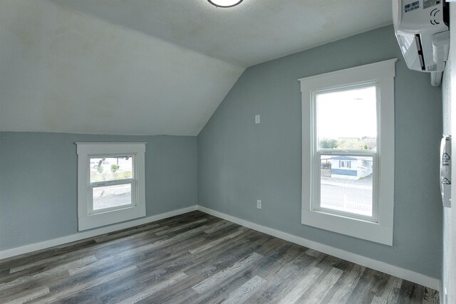 503 Grandridge Ave, Grandview, WA 98930 - bonus room with a wall mounted AC, dark wood-style floors, and baseboards
