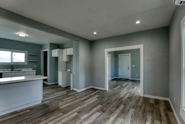 503 Grandridge Ave, Grandview, WA 98930 - kitchen with baseboards, dark wood-type flooring, white cabinetry, and a sink