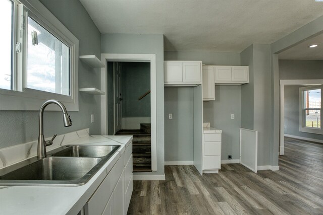 503 Grandridge Ave, Grandview, WA 98930 - kitchen with dark wood-type flooring, open shelves, white cabinetry, a sink, and baseboards