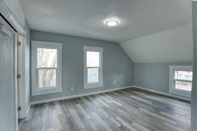 503 Grandridge Ave, Grandview, WA 98930 - bonus room with a textured ceiling, wood finished floors, lofted ceiling, and plenty of natural light