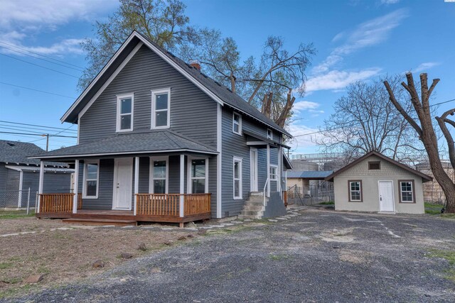 503 Grandridge Ave, Grandview, WA 98930 - view of front facade with a shingled roof, an outdoor structure, and covered porch
