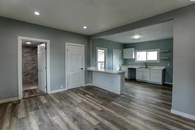 503 Grandridge Ave, Grandview, WA 98930 - kitchen featuring white cabinets, dark wood-type flooring, light countertops, and a sink