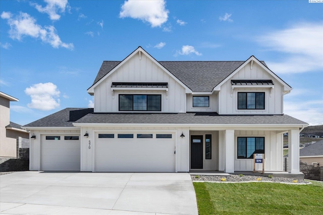 modern farmhouse style home with an attached garage, concrete driveway, roof with shingles, a front lawn, and board and batten siding