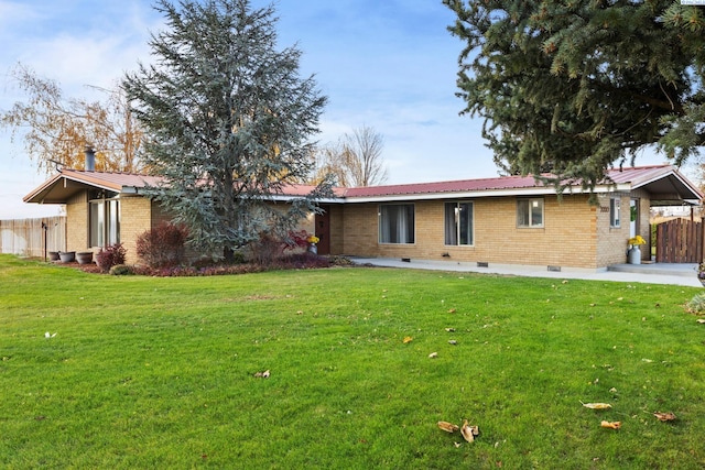 back of property with a patio and a lawn