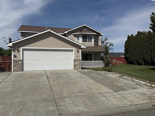 808 N Owen Ave, Pasco, WA 99301 - view of front of home with concrete driveway, brick siding, an attached garage, and a porch