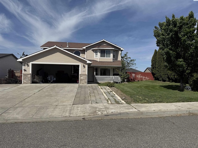 808 N Owen Ave, Pasco, WA 99301 - view of front facade featuring a garage, covered porch, a front lawn, concrete driveway, and brick siding