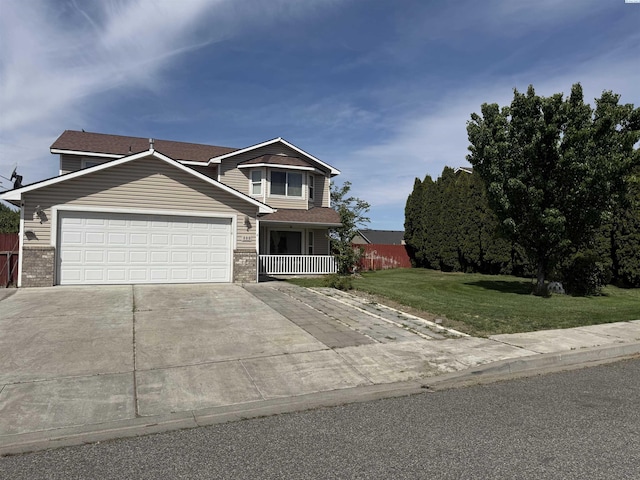 808 N Owen Ave, Pasco, WA 99301 - view of front of property featuring a front yard, concrete driveway, a garage, and brick siding