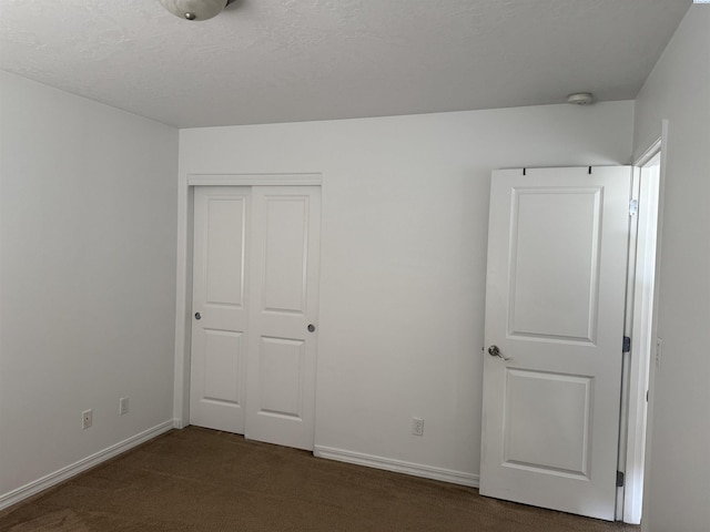 808 N Owen Ave, Pasco, WA 99301 - unfurnished bedroom featuring dark carpet, a closet, and baseboards